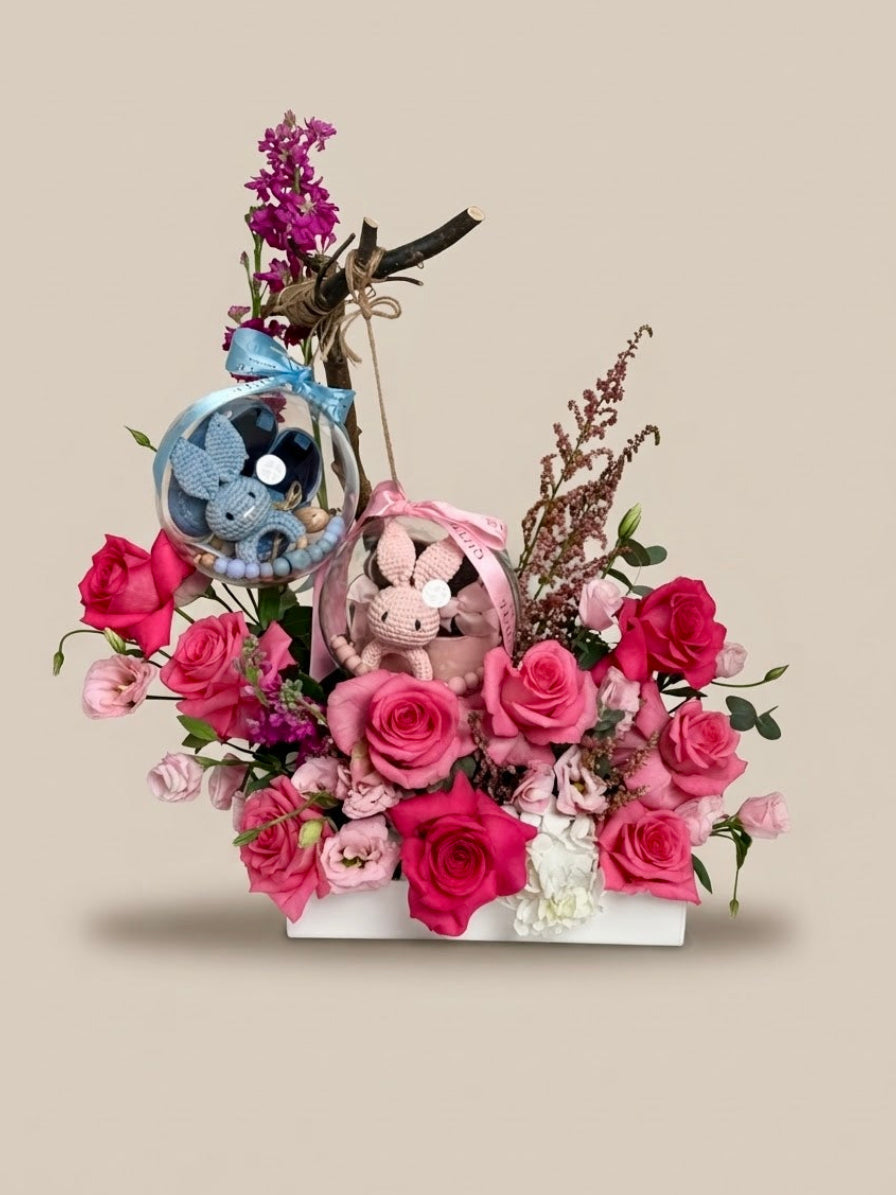 Baby Bloom Bubble twin newborn flower arrangement featuring pink roses and dual acrylic keepsake bubbles with a blue boy set and pink girl set.
