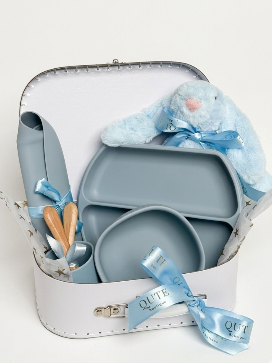 Personalised dusty blue baby boy silicone feeding set with plush blue bunny, suction plate, bib, and engraved spoons in Qute white vintage keepsake trunk in Doha Qatar
