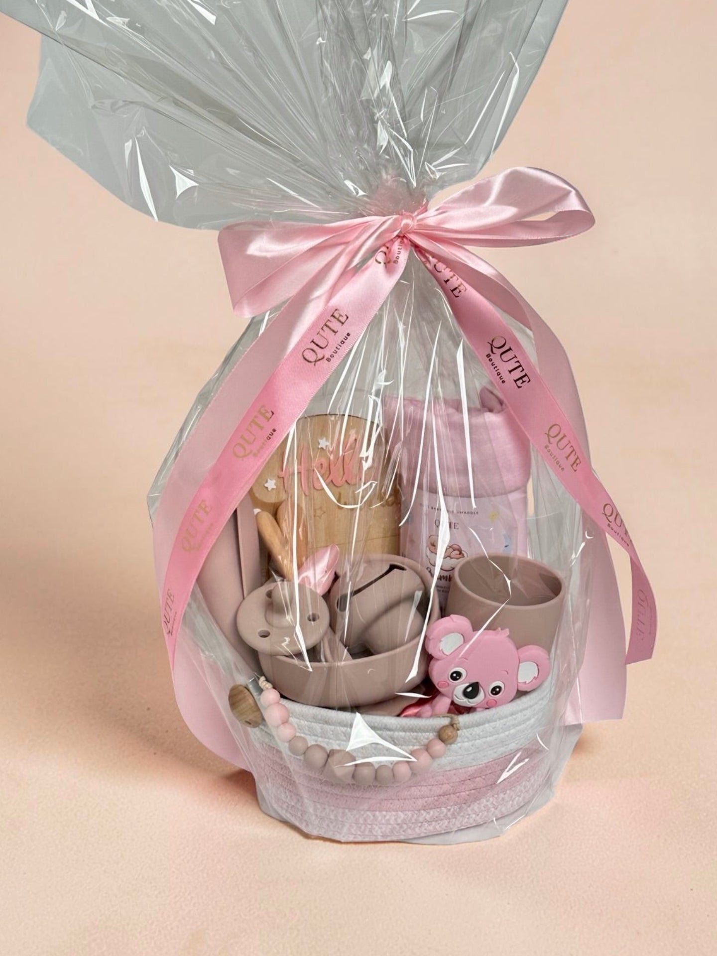 Luxury newborn baby gift hamper in clear gift wrap packaging with blue signature ribbon—Qute Gifts Doha