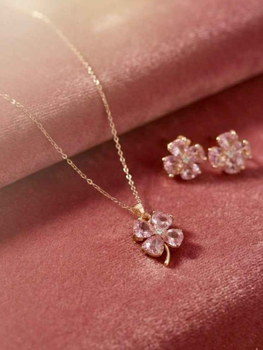 Blush pink crystal four-leaf clover jewelry gift set for women and moms in Qatar featuring gold chain pendant necklace and matching clover stud earrings by Elara Jewellery Doha