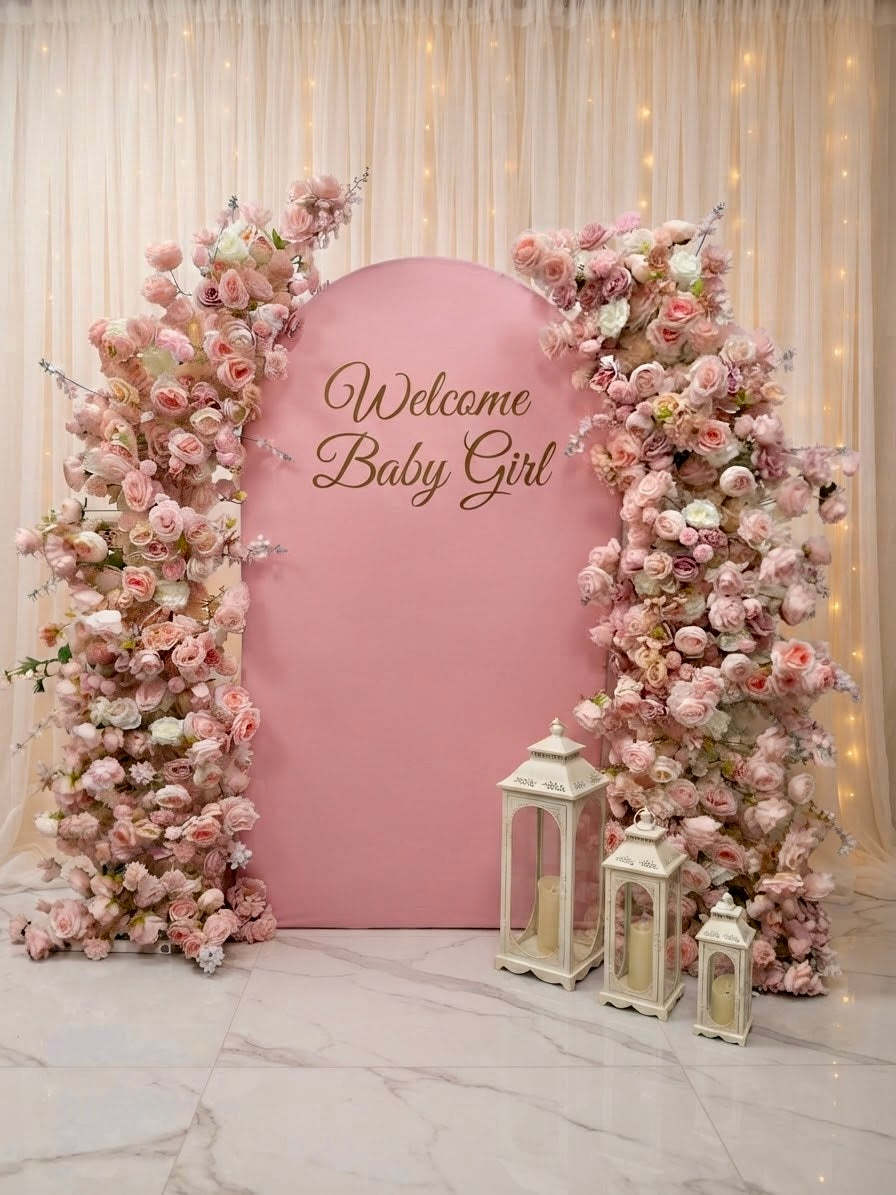 Luxury pink faux floral arch backdrop by Qute Qatar, featuring cascading artificial roses and an arched display designed for weddings, engagements, and baby showers in Doha.