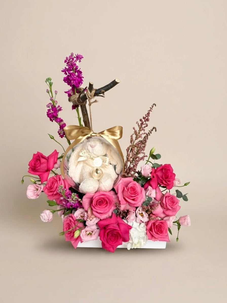 Pregnancy announcement flower box featuring luxury floral art by Plaza Hollandi and an acrylic keepsake bubble with a plush bunny and hidden message for family.