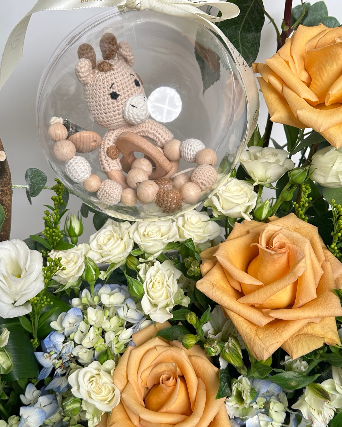 Special baby boy gift box featuring luxury champagne roses and an acrylic keepsake bubble packed with custom newborn items for welcoming a newborn son.