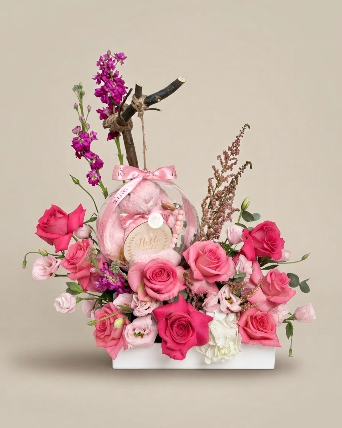 Baby Bloom Bubble newborn flower arrangement featuring pink roses and an acrylic keepsake bubble filled with a custom-name plush bunny, Hello World card, and a personalized pacifier clip.