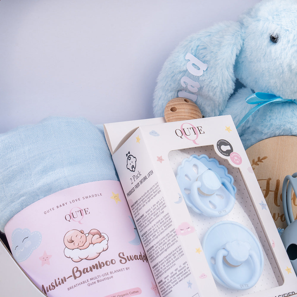 Plaza Hollandi x Qute baby boy gift set in white vintage keepsake suitcase with plush blue bunny and bamboo swaddle in Doha Qatar