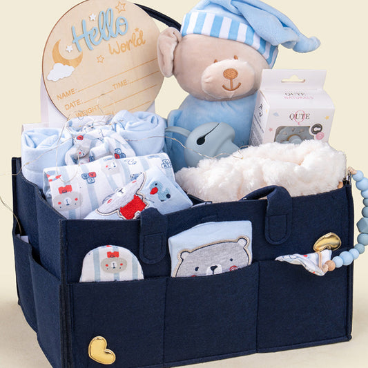 Navy blue baby organizer with baby items including a teddy bear, clothes, and a 'Hello World' sign on a beige background.