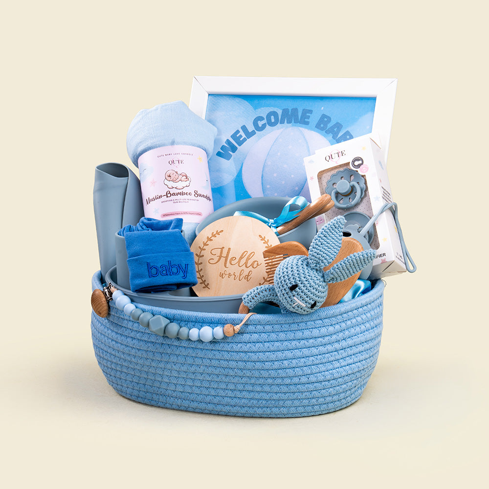 Plaza Hollandi x Qute luxury baby boy gift set in blue woven rope hamper featuring silicone feeding tableware, bamboo swaddle, and keepsakes for baby boy gifts in Doha Qatar