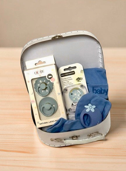 Personalised baby boy gift set featuring royal blue knitted baby clothing, Qute natural latex pacifiers, pacifier chain, and flower teether ring in white gift trunk in Doha Qatar