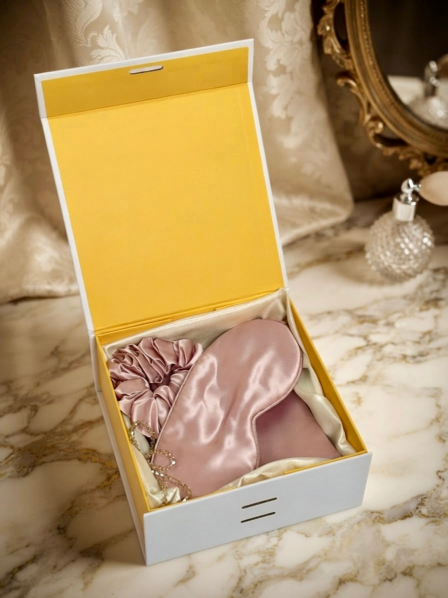 Luxury 100% mulberry silk self-care gift set for women by Qute Qatar, featuring a pink silk pillowcase, eye mask, and scrunchie inside a luxury gift box for postpartum and birthday gifting in Doha.