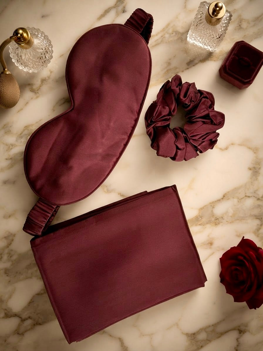 Luxury 100% mulberry silk self-care gift set in ruby red by Qute Qatar, featuring a ruby silk pillowcase, eye mask, and scrunchie inside a luxury gift box for postpartum and birthday gifting in Doha.