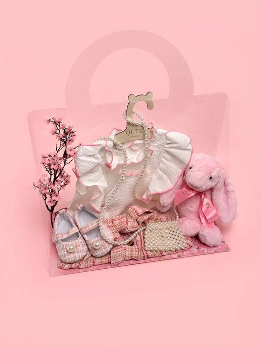 Luxury baby girl gift set for 12-18 months by Qute Qatar, featuring a pink and gold tweed skirt outfit, matching shoes, pearl mini bag, and a plush pink bunny for delivery in Doha.