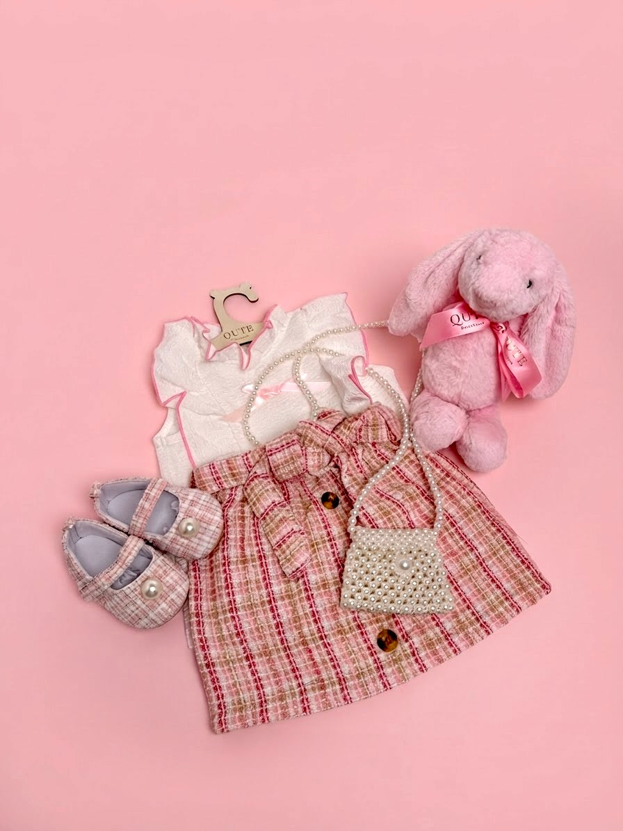Luxury baby girl gift set for 12-18 months by Qute Qatar, featuring a pink and gold tweed skirt outfit, matching shoes, pearl mini bag, and a plush pink bunny for delivery in Doha.