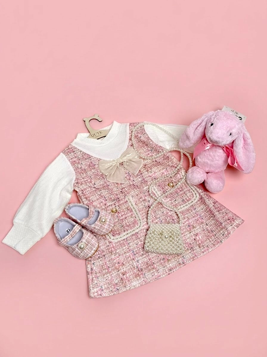 Luxury baby girl gift set for 12-18 months in a clear presentation bag by Qute Qatar, featuring a pink tweed dress, matching shoes, pearl mini bag, and a plush pink bunny for delivery in Doha.