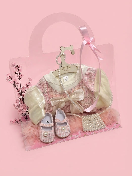 Luxury first birthday baby girl gift set by Qute Qatar with personalized packaging, featuring a 12-18 months pink tweed dress, matching pearl shoes, and handbag for delivery in Doha.