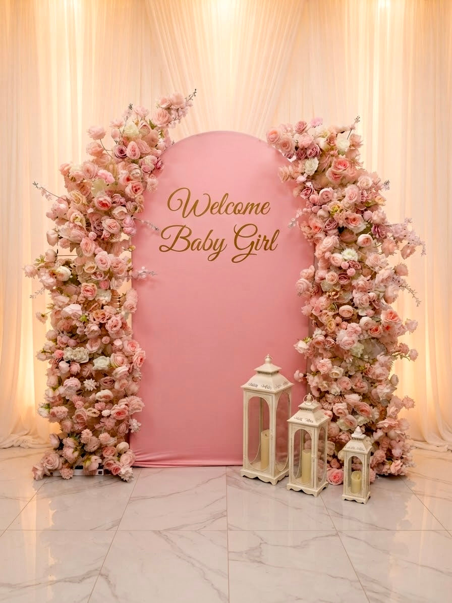 Luxury pink faux floral arch backdrop by Qute Qatar, featuring cascading artificial roses and an arched display designed for weddings, engagements, and baby showers in Doha.