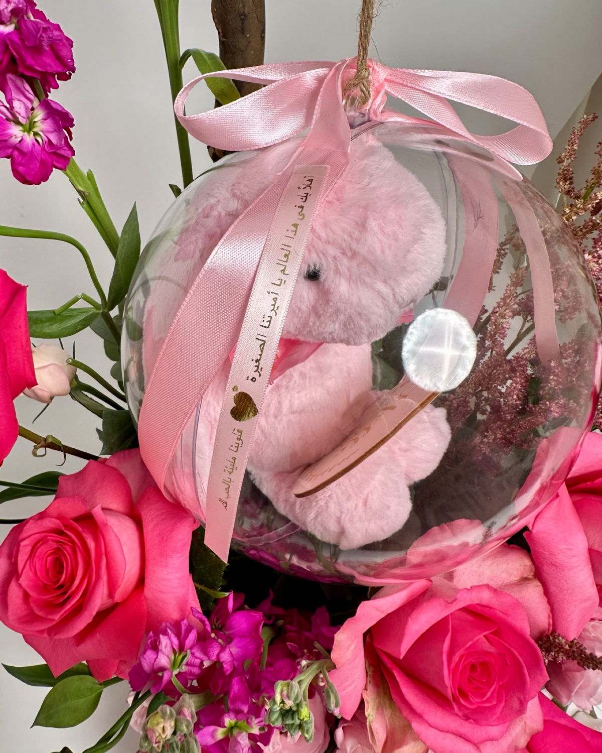 Same-day baby girl gift featuring a luxury floral box with pink roses and a "Hello Little One" acrylic keepsake bubble, designed for welcoming a newborn.   