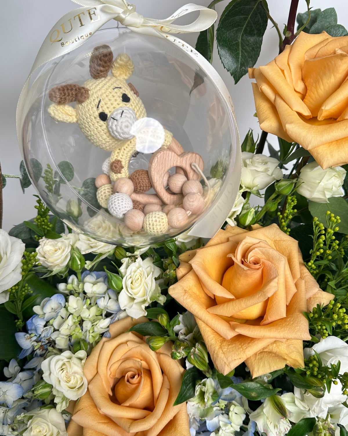 Special baby boy gift box featuring luxury champagne roses and an acrylic keepsake bubble packed with custom newborn items for welcoming a newborn son.