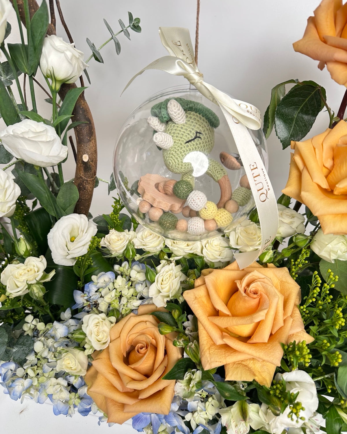 Special baby boy gift box featuring luxury champagne roses and an acrylic keepsake bubble packed with custom newborn items for welcoming a newborn son.   